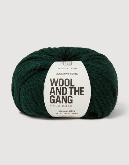 Alpachino Merino, Dark green skein of yarn with 'Wool and the Gang' label on a light gray background
