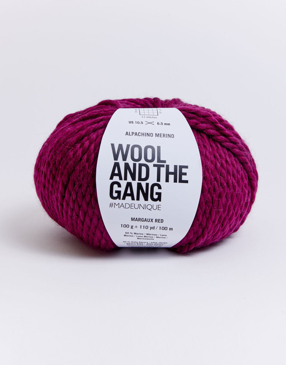 Alpachino Merino, Ball of pink yarn with 'Wool and the Gang' label on a white background