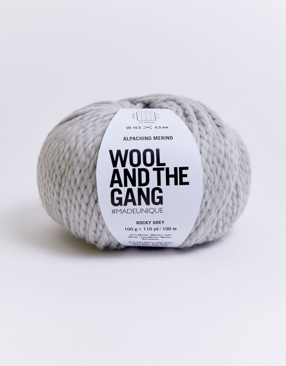Alpachino Merino, Gray yarn skein with 'Wool and the Gang' label on a white background