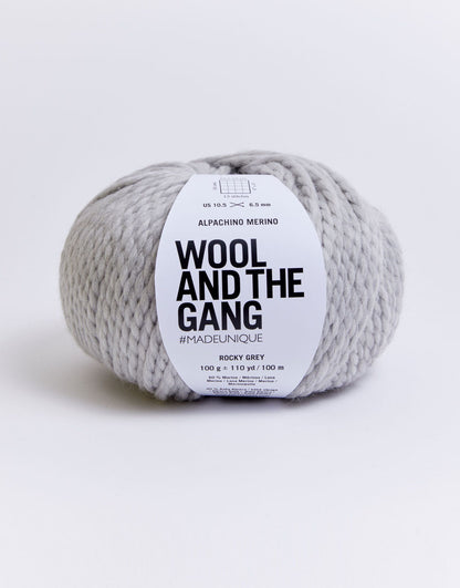 Alpachino Merino, Gray yarn skein with 'Wool and the Gang' label on a white background