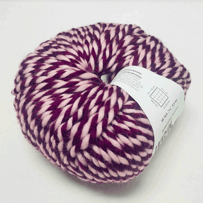 Alpachino Merino, Ball of purple and pink yarn with a label on a white background