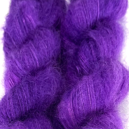 Delicious by Apple Fiber Studio. Two fluffy braided hair extensions in a vibrant purple color, shown against a plain white background.