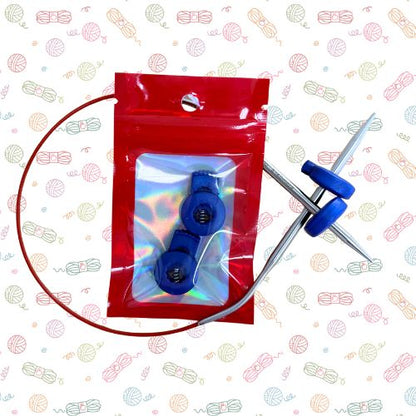 Point Protectors: A pair of circular knitting needles with blue adjustable knobs, shown with a red plastic storage pouch containing two matching blue knobs. The background is white with a repeating pastel yarn ball pattern.