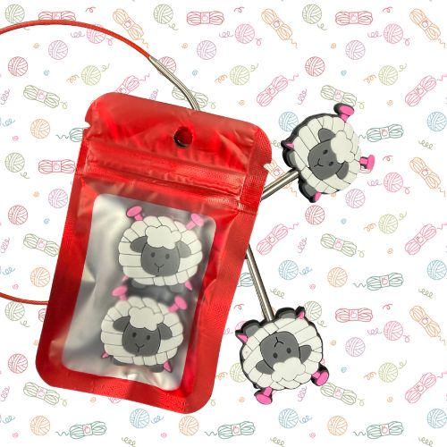 Point Protectors: A red zippered pouch with a clear front window displaying two cartoon sheep charms, shown with two matching sheep charms attached to a metal wire on a patterned white background.