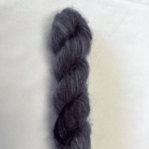 Photo of Apple Fiber Studio Delicious in the color Shadow. Color description: dark, moody tonal grey with purple overtones.